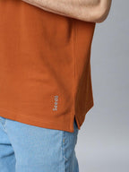 The Jacquard Polo in Rust with Navy